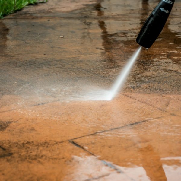 Cleaning backyard with pressure washer. Spring clean up